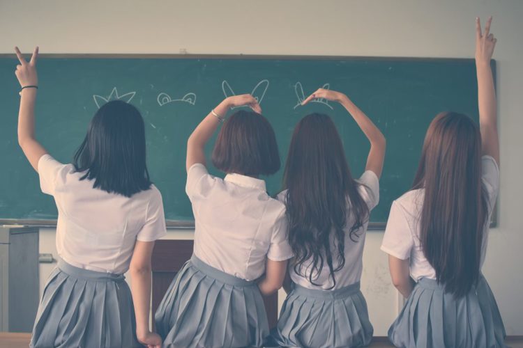 4 girls raising their hands