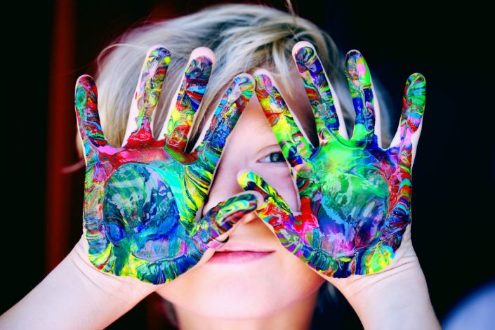 a kid with painted hands